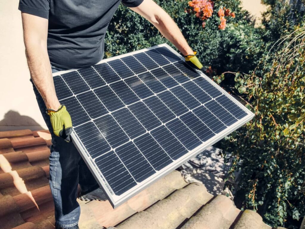 a photo of a man installing a diy solar panel